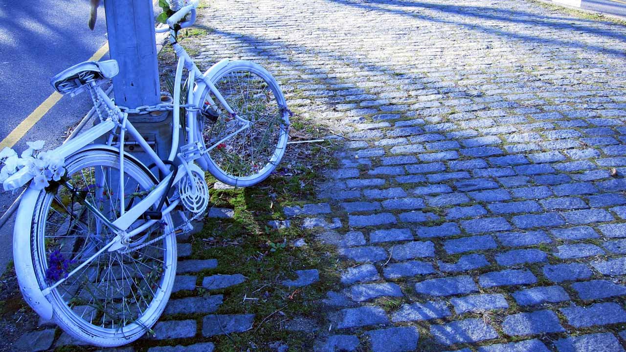 ghost bike on street corner memorial